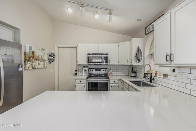 3856 E Encinas Ave, Gilbert, AZ 85234 - kitchen with appliances with stainless steel finishes, a sink, lofted ceiling, backsplash, and light countertops