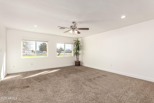 carpeted spare room featuring ceiling fan