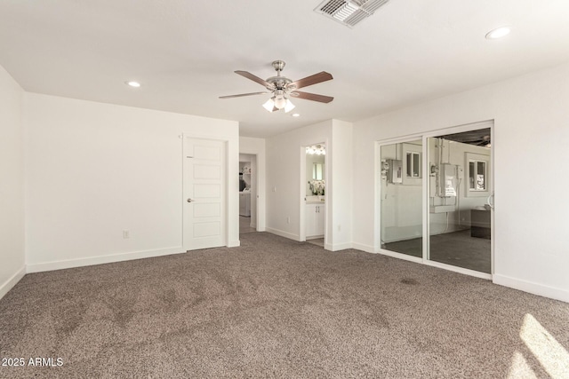 unfurnished bedroom featuring ensuite bath, carpet floors, and ceiling fan