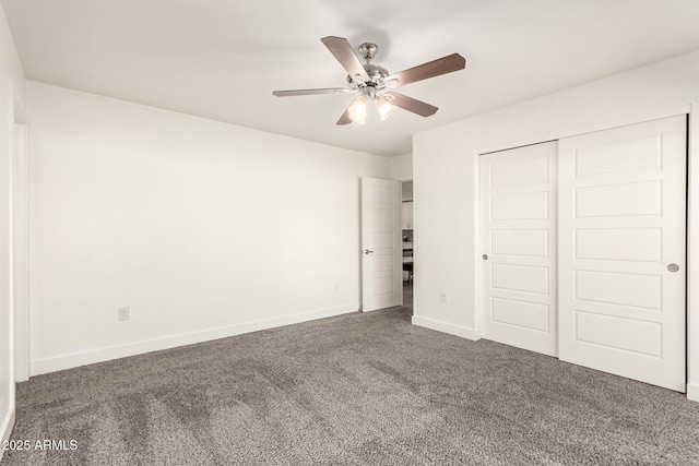 unfurnished bedroom featuring ceiling fan, dark carpet, and a closet