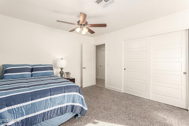 carpeted bedroom with ceiling fan and a closet