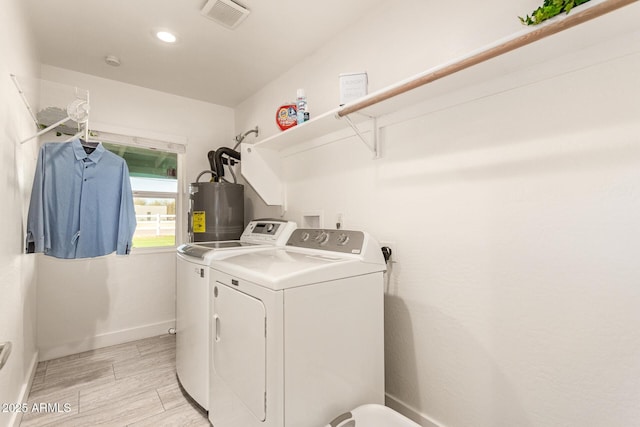 laundry area featuring washing machine and dryer and water heater