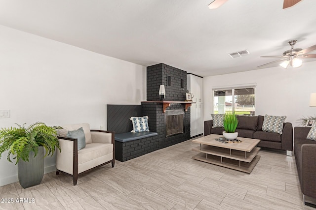 living room with a fireplace and ceiling fan