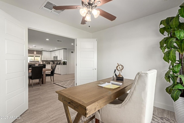 home office featuring ceiling fan and light wood-type flooring