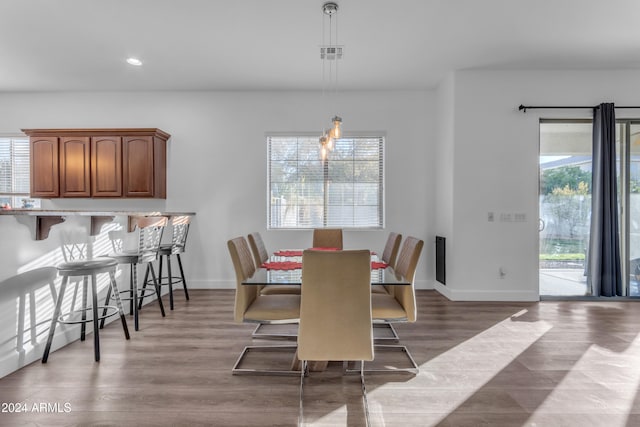 dining room with plenty of natural light and dark hardwood / wood-style floors