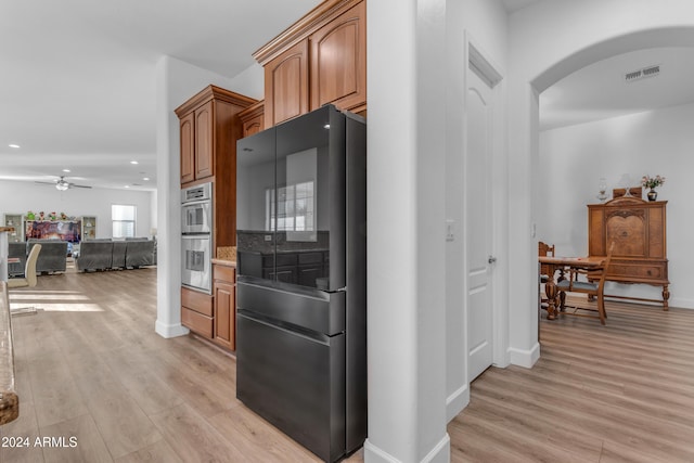 kitchen with ceiling fan, appliances with stainless steel finishes, and light hardwood / wood-style flooring