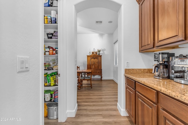 interior space featuring light stone countertops and light hardwood / wood-style floors