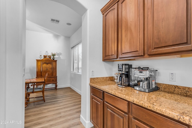 kitchen featuring light stone countertops and light wood-type flooring