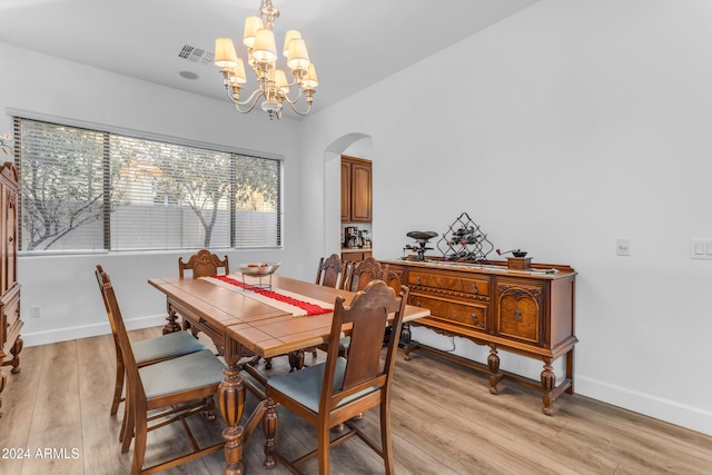 dining room featuring a chandelier and light hardwood / wood-style flooring