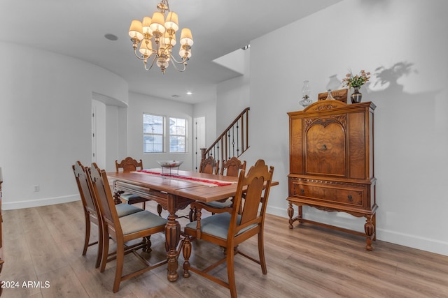 dining space with an inviting chandelier and light hardwood / wood-style floors