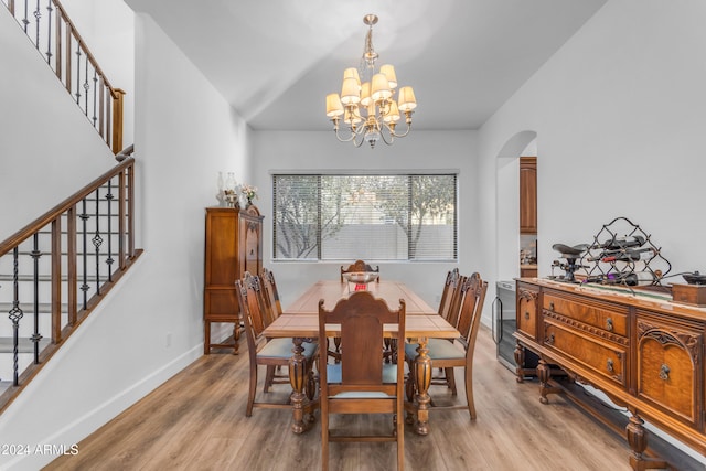 dining room with a chandelier and light hardwood / wood-style flooring