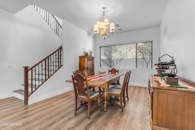 dining room featuring light hardwood / wood-style flooring and a notable chandelier