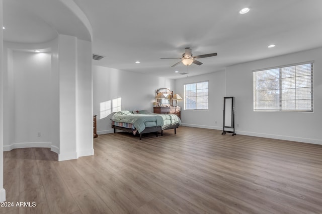 bedroom with ceiling fan and light hardwood / wood-style flooring