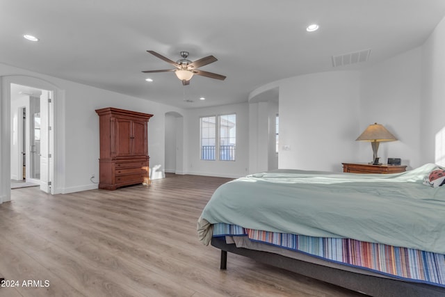 bedroom with light hardwood / wood-style flooring and ceiling fan