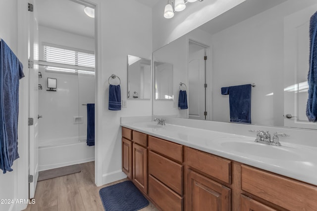 bathroom with vanity, hardwood / wood-style flooring, and  shower combination