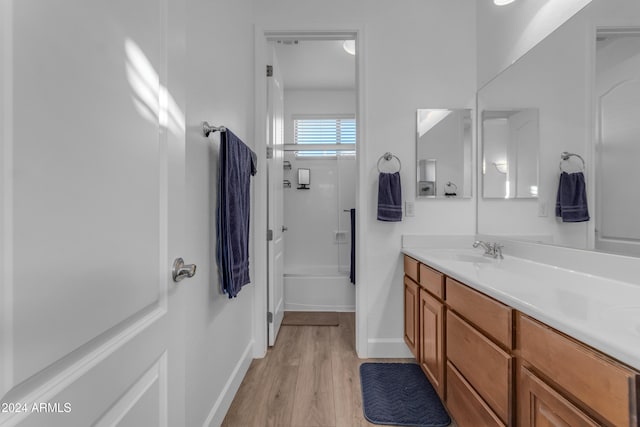 bathroom with vanity, hardwood / wood-style flooring, and shower / bathtub combination