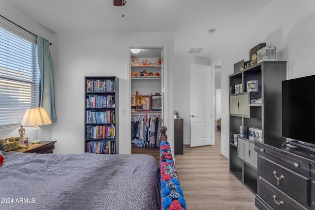 bedroom featuring a closet, ceiling fan, and light hardwood / wood-style flooring