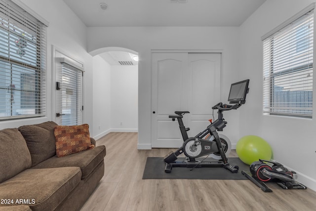 workout room featuring light wood-type flooring