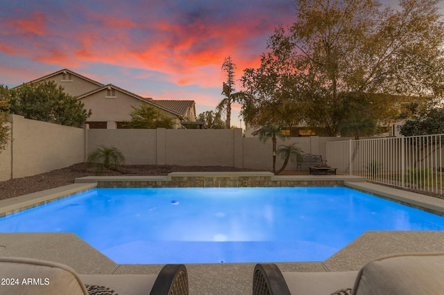 view of pool at dusk