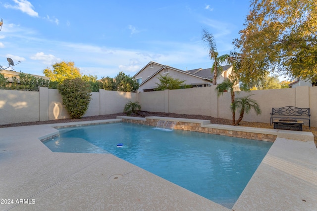 view of swimming pool with a patio area and pool water feature