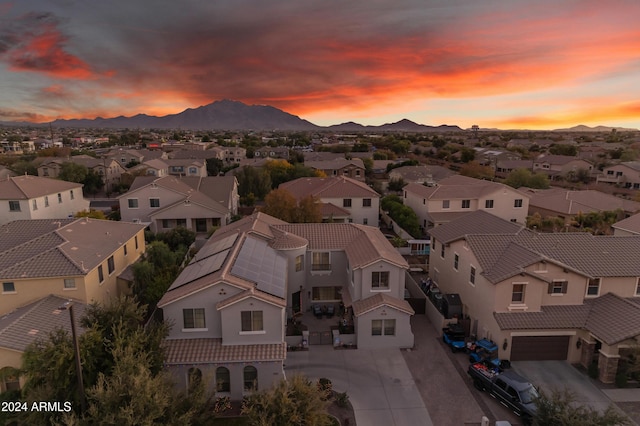 aerial view at dusk featuring a mountain view