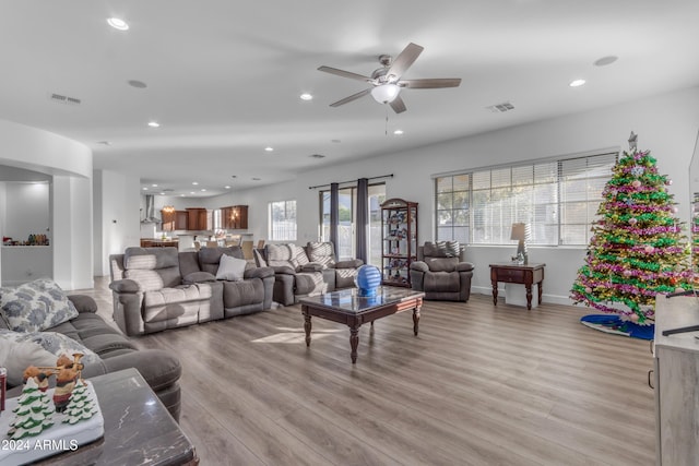 living room with light hardwood / wood-style floors and ceiling fan