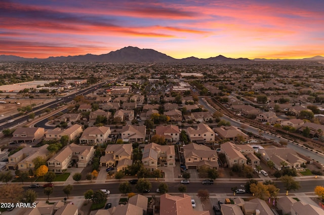 aerial view at dusk featuring a mountain view