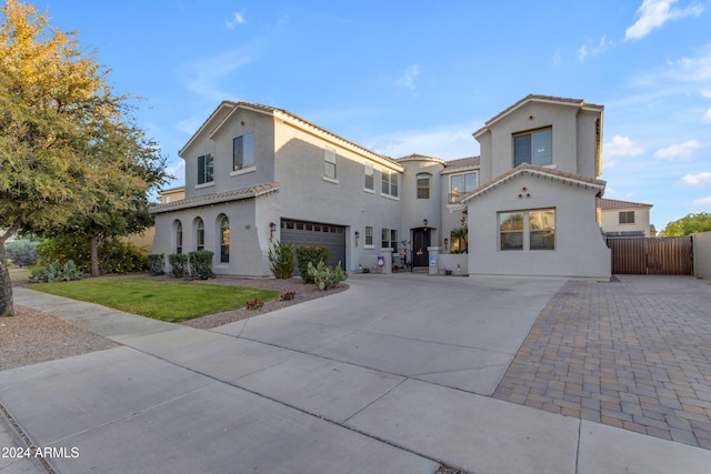 back of property with a garage and a yard