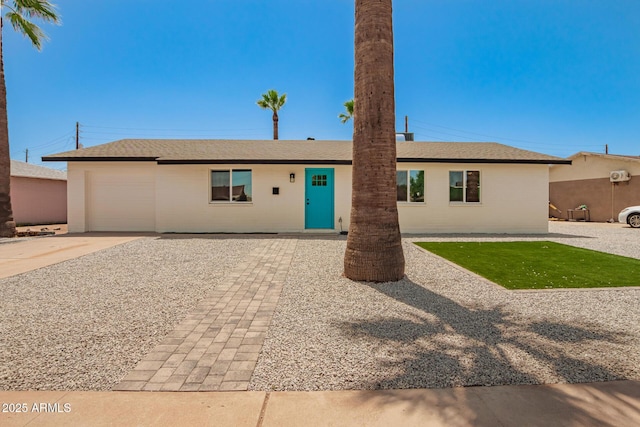 ranch-style house featuring an attached garage and driveway