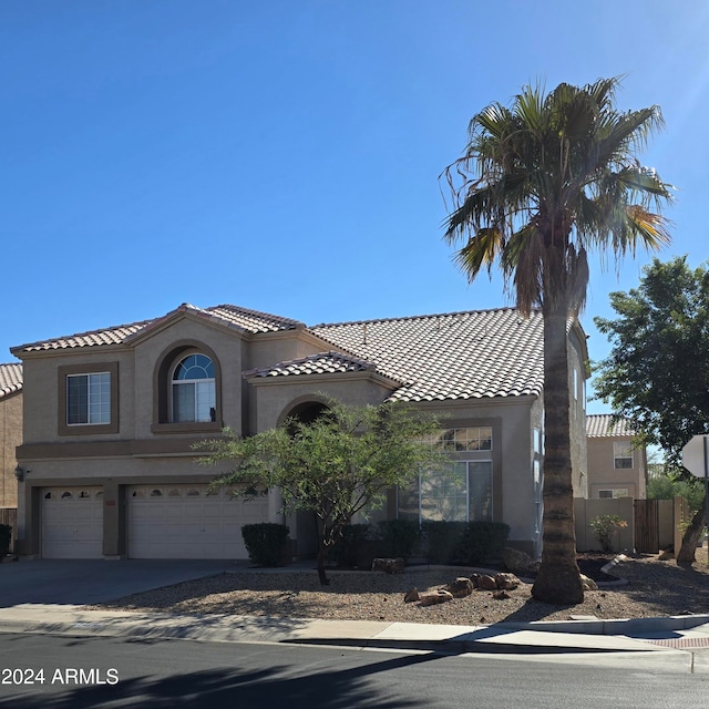 mediterranean / spanish-style home featuring a garage