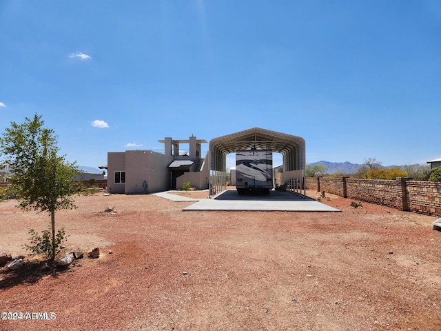 rear view of property with a carport