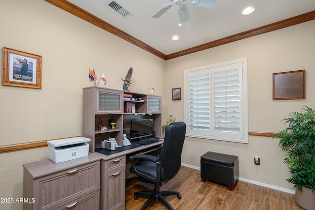 home office with light wood finished floors, ornamental molding, visible vents, and baseboards