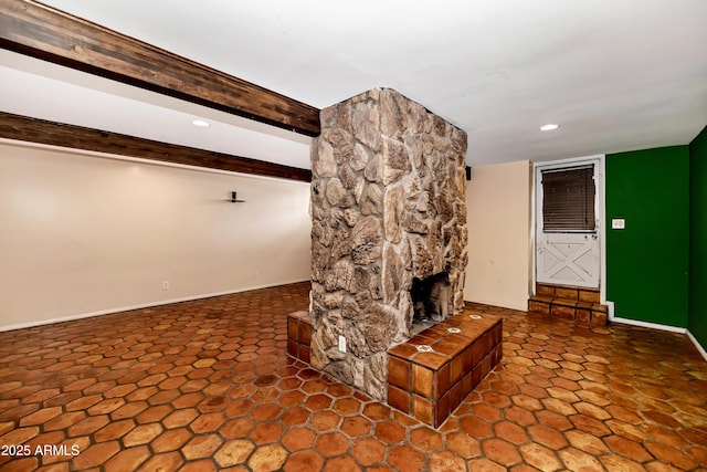 unfurnished living room featuring baseboards, a stone fireplace, beam ceiling, and recessed lighting