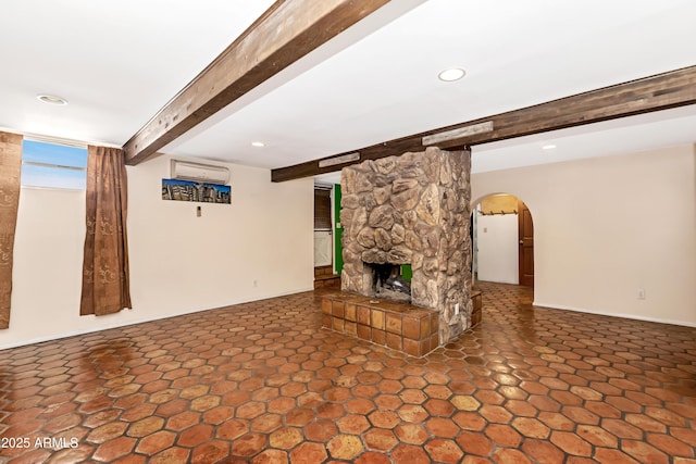 unfurnished living room with arched walkways, a wall mounted air conditioner, beam ceiling, and recessed lighting