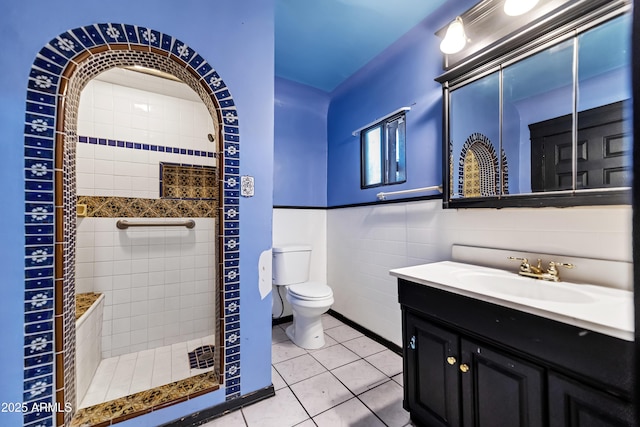 bathroom featuring vanity, a shower stall, toilet, and tile patterned floors