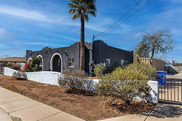 view of front of house featuring a fenced front yard and stucco siding