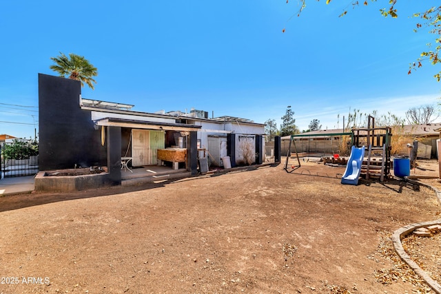 exterior space with a playground and fence