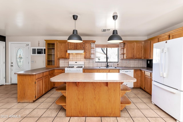 kitchen with open shelves, white appliances, a kitchen island, and light countertops