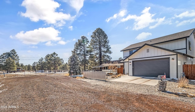 3588 Huron, Flagstaff, AZ 86005 - view of property exterior featuring driveway, fence, board and batten siding, and an attached garage