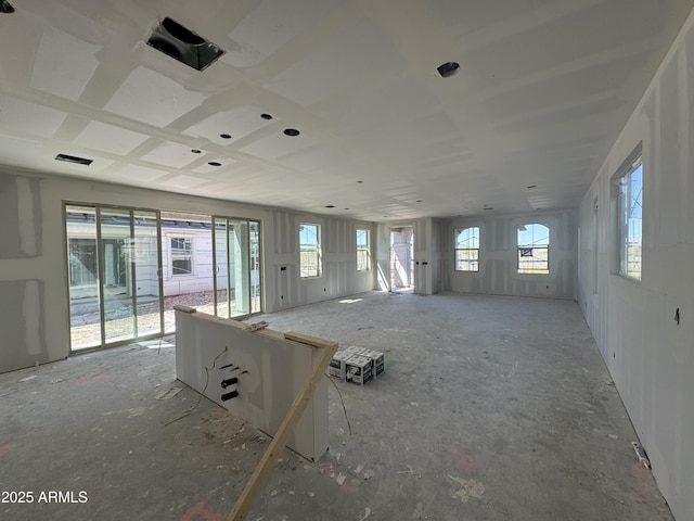 unfurnished living room with visible vents