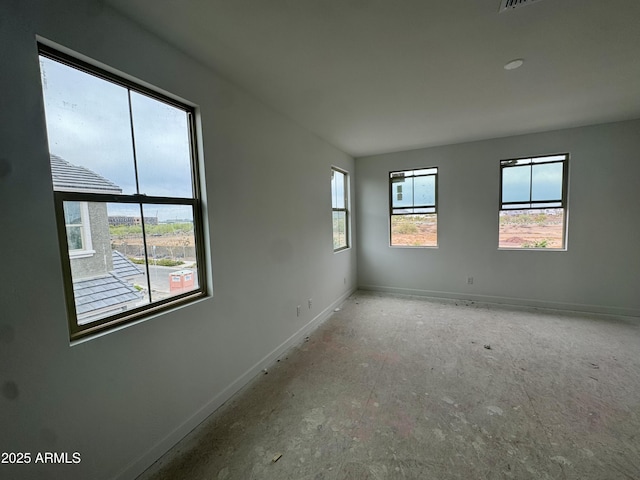 unfurnished room featuring baseboards