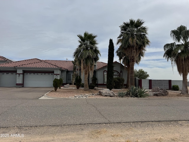 view of front facade featuring driveway, a garage, and stucco siding