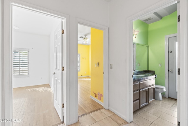 bathroom featuring tile patterned flooring, vanity, toilet, and ceiling fan