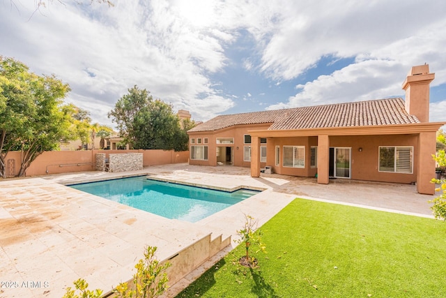 view of pool with a patio and a yard