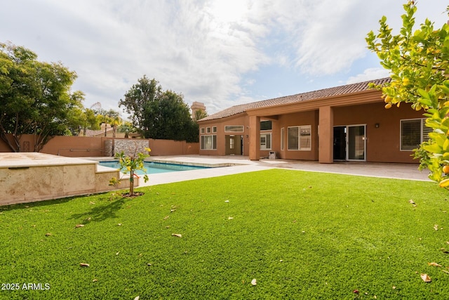 back of property featuring a patio and a lawn