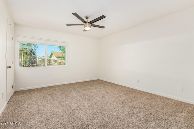 unfurnished room featuring ceiling fan and carpet