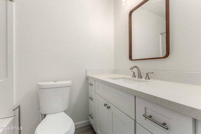 bathroom featuring vanity and toilet