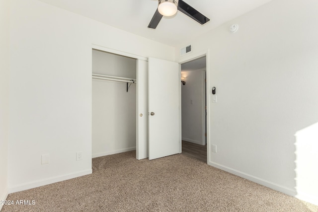 unfurnished bedroom with a closet, ceiling fan, and carpet flooring