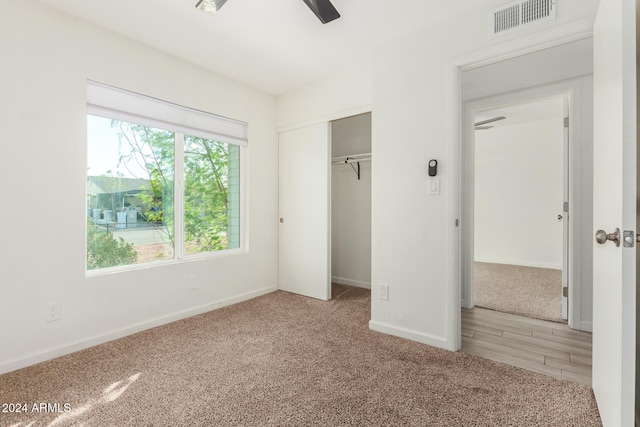 unfurnished bedroom with carpet floors, a closet, and ceiling fan