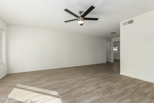 spare room featuring light wood-type flooring and ceiling fan